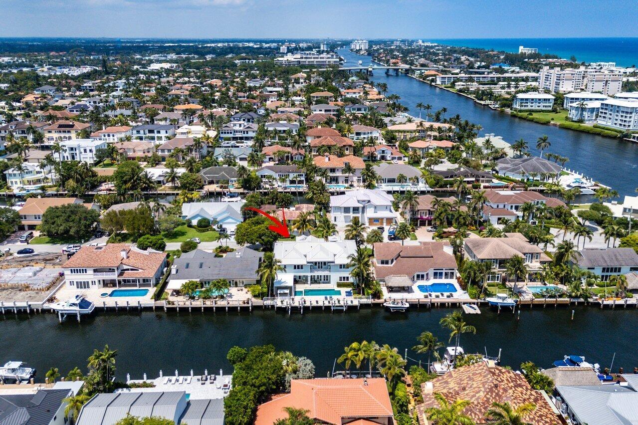 An aerial view of a waterfront house with a pool and dock on a canal — 960 Dogwood Drive, Delray Beach FL 33483, DELRAY BEACH, FL