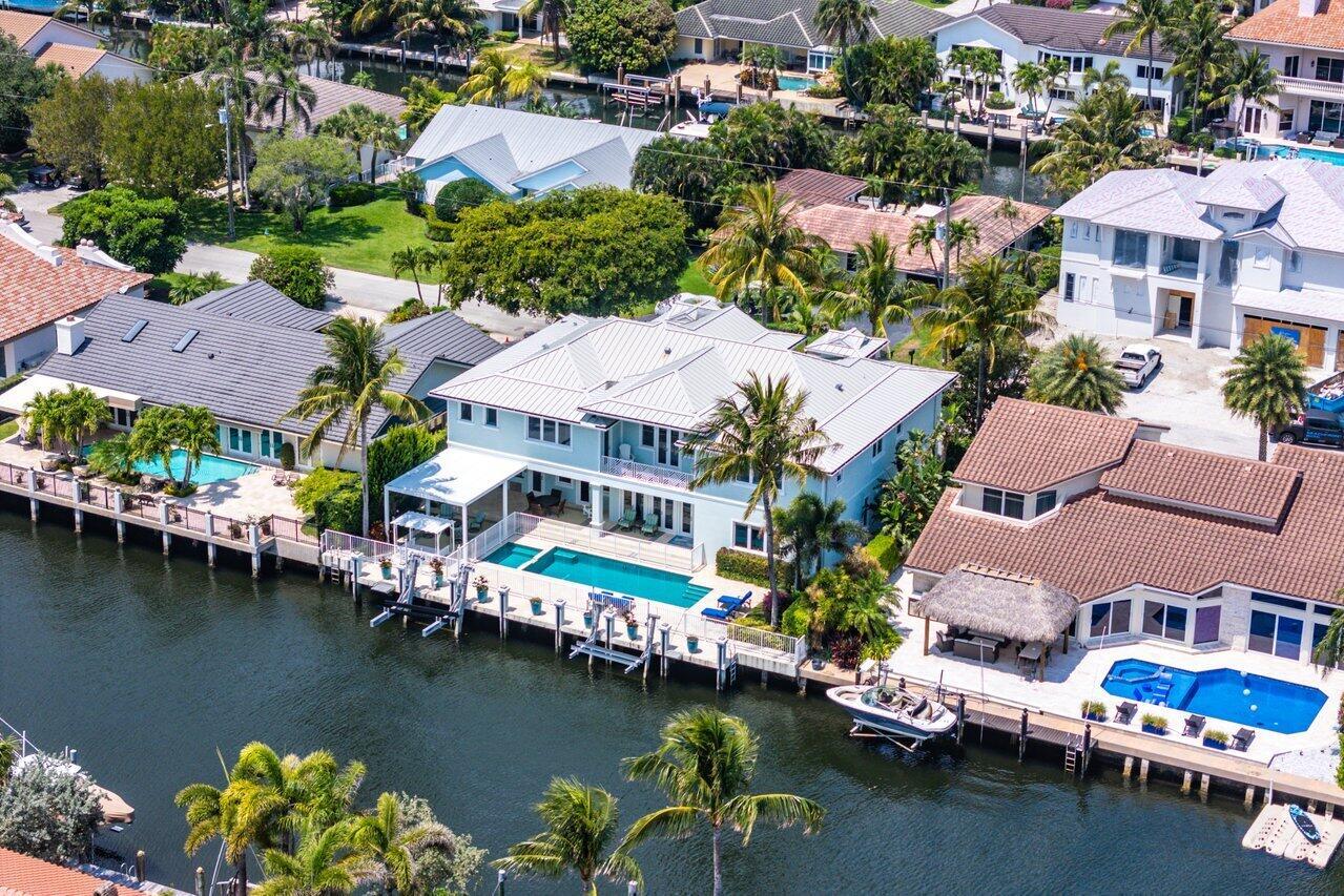 An aerial view of a waterfront house with a swimming pool and private boat dock — 960 Dogwood Drive, Delray Beach FL 33483, DELRAY BEACH, FL