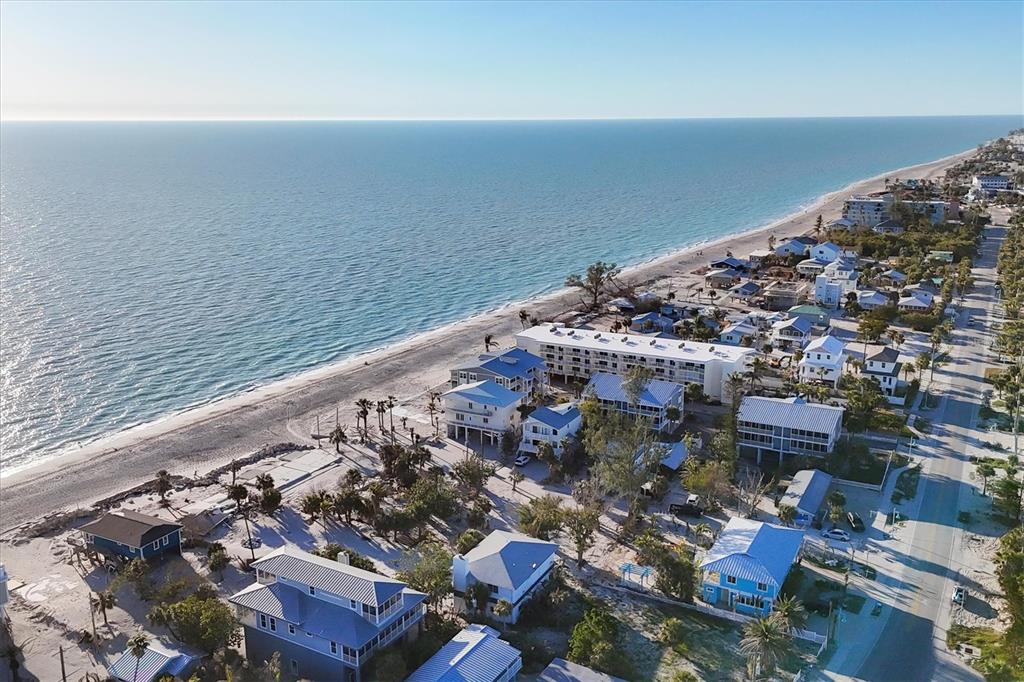 An aerial view of a coastal beach town with houses, a hotel, and the ocean — 65 BEACHCOMBER LANE UNIT B, ENGLEWOOD, FL