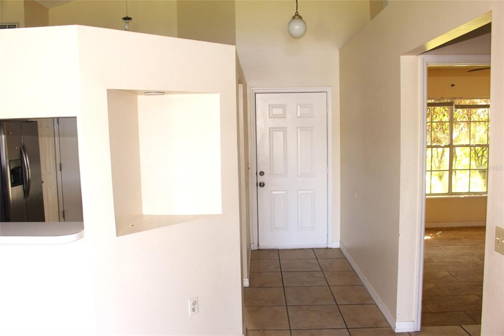 A view of an entryway with tile flooring, a white front door, and a wall cutout — 3036 DELLCREST PLACE, LAKE MARY, FL