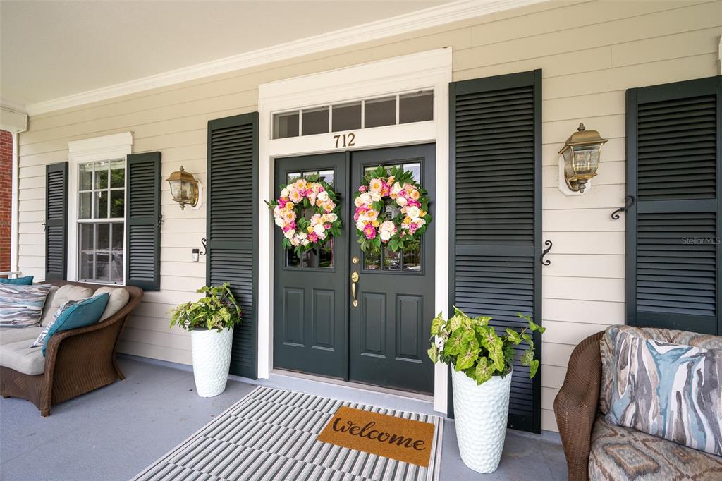 A two-story house with beige siding, a front porch, and a concrete walkway — 712 TEAL AVENUE, CELEBRATION, FL