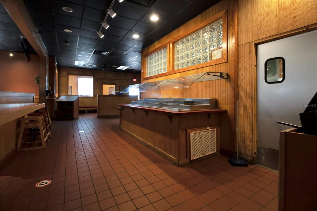 A commercial space features a buffet counter, tiled flooring, and a black drop ceiling — 1152 TAMIAMI TRAIL, PORT CHARLOTTE, FL