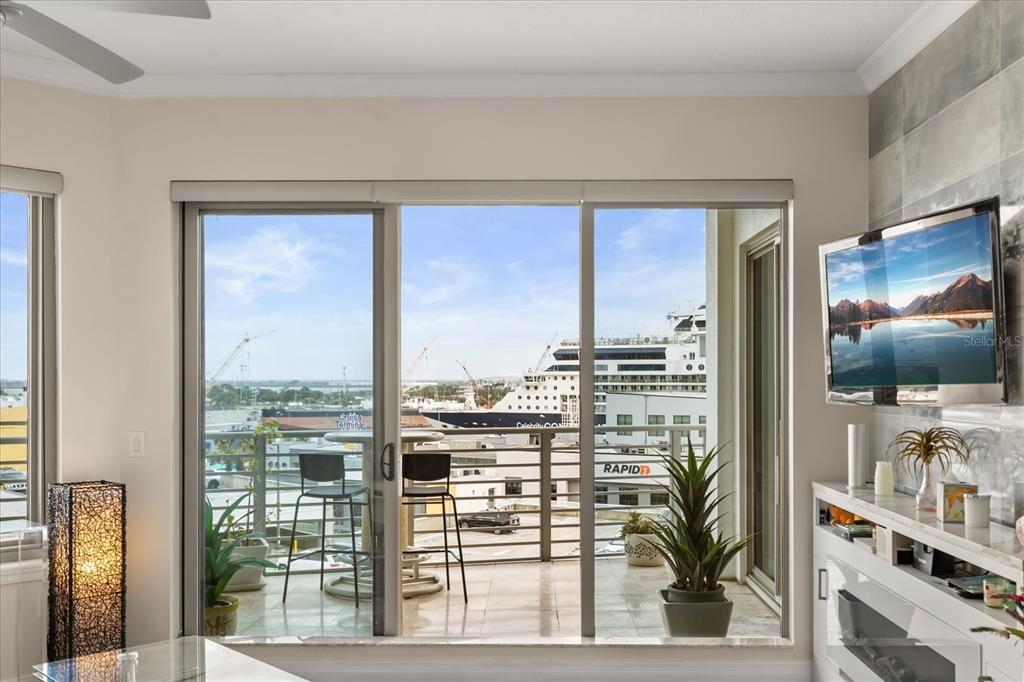A living room with a balcony view of a cruise ship docked at a port — 1209 E CUMBERLAND AVENUE UNIT 807, TAMPA, FL