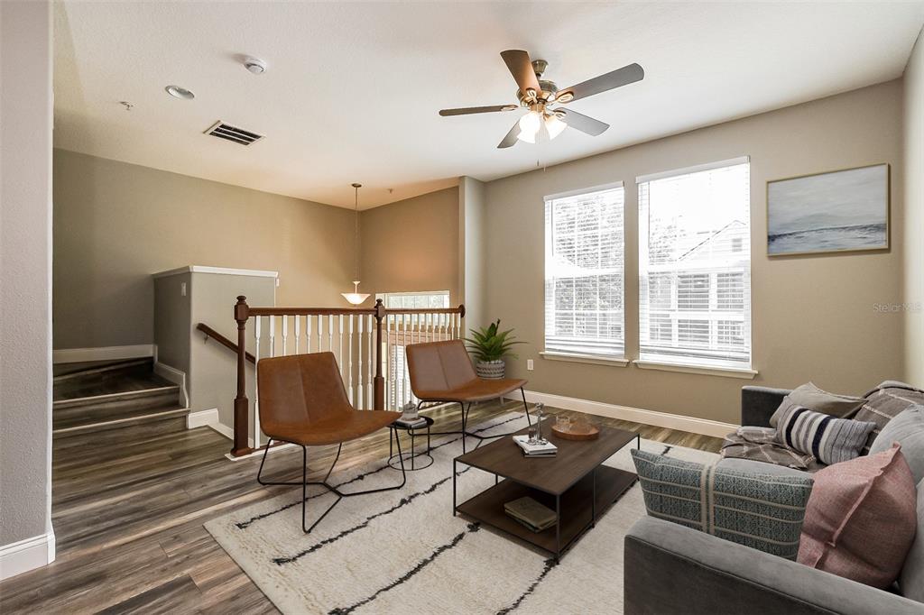 A living room features wood-look flooring, a ceiling fan, two leather chairs, and a sofa — 1384 MILL STREAM LANE, WINTER SPRINGS, FL