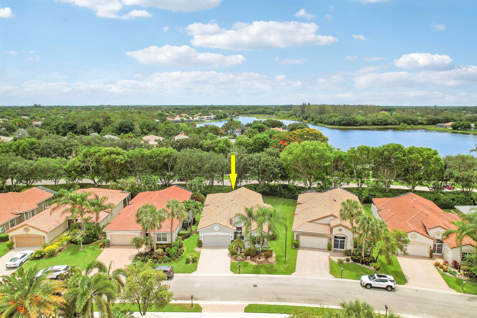 An aerial view shows a suburban house with a yellow arrow pointing to its roof — 6554 Pavone Street, Lake Worth FL 33467, LAKE WORTH, FL
