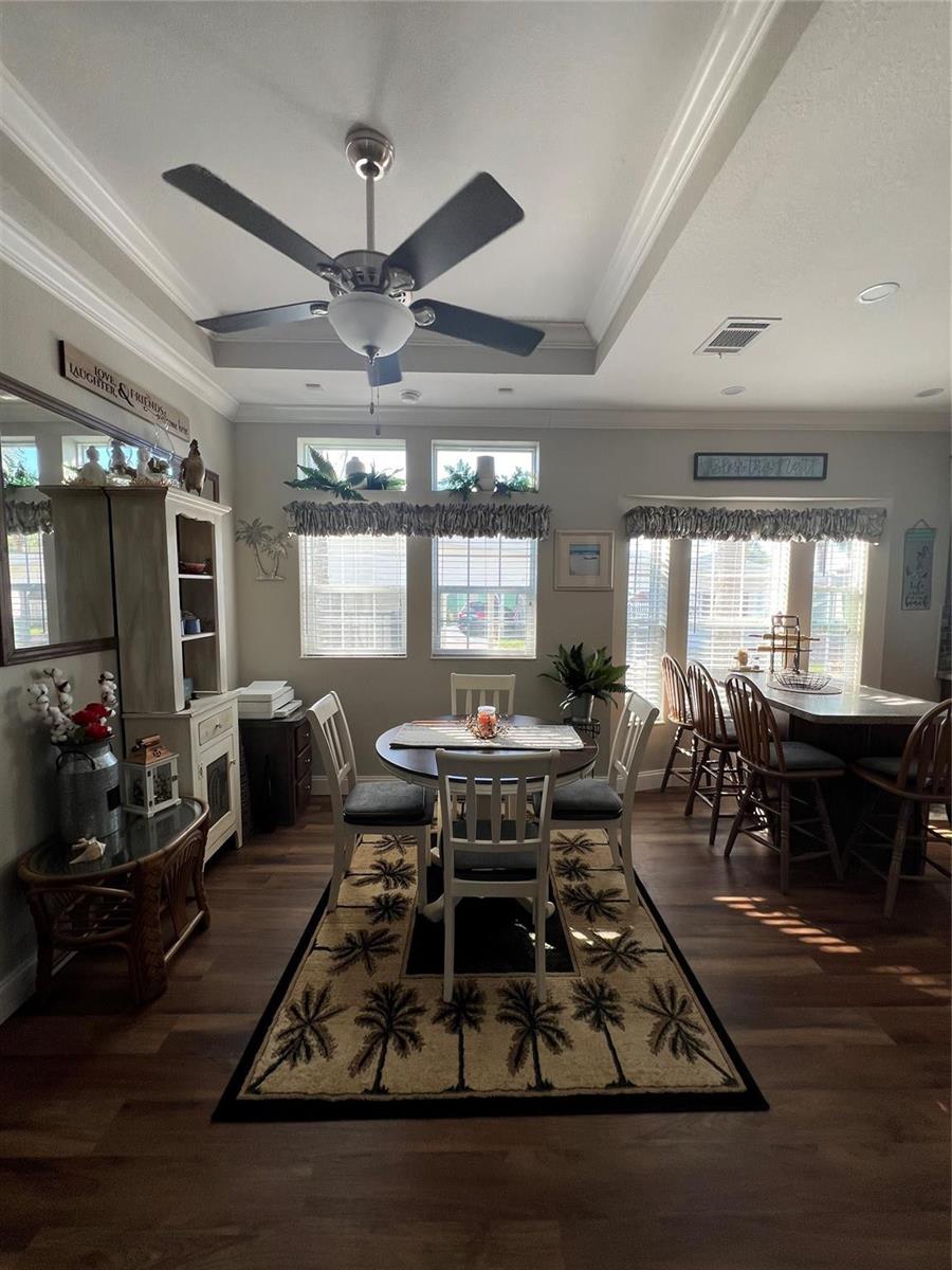 A dining area features a round table, chairs, a rug, and a kitchen island — 6601 SE 51st Street, Okeechobee FL 34974, OKEECHOBEE, FL