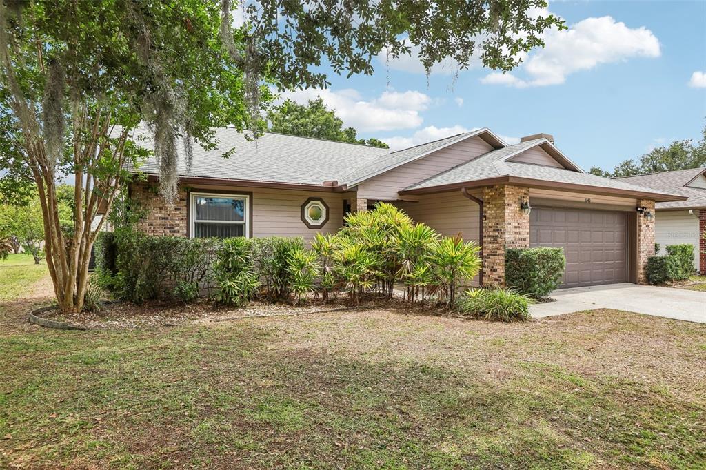 A single-story house with a brick and siding facade, a two-car garage, and a driveway — 6540 FOXMOOR DRIVE, ZEPHYRHILLS, FL