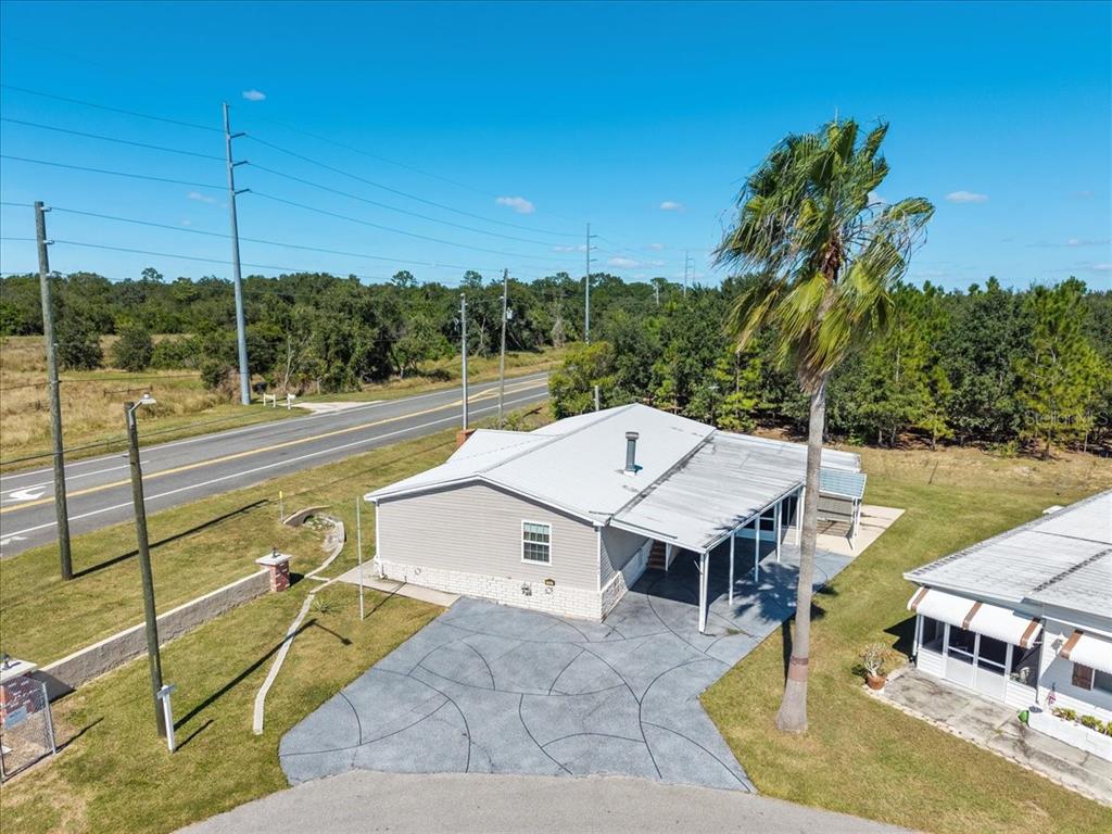 An aerial view of a single-story house with a patterned concrete driveway and palm tree — 101 EDGEWOOD BOULEVARD, LAKE WALES, FL