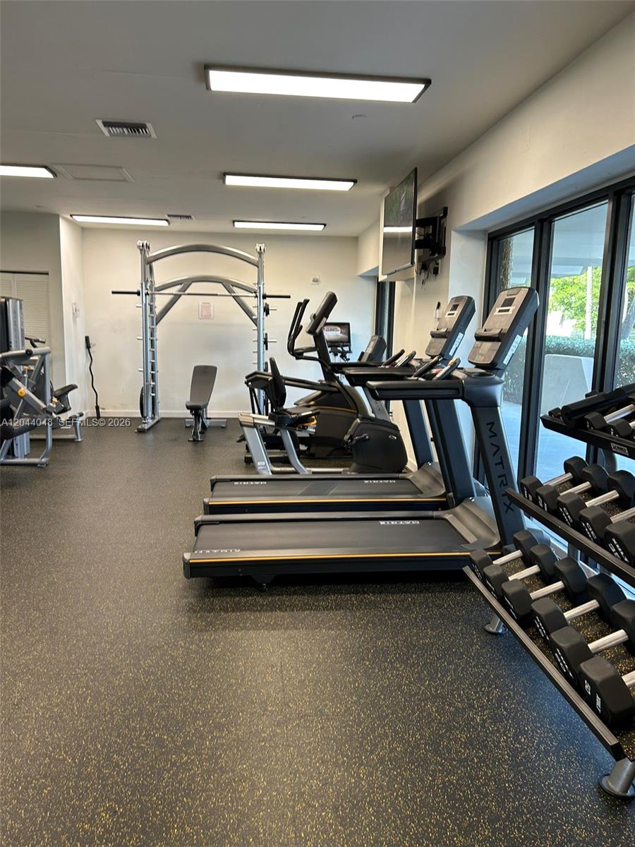 A gym features treadmills, a weight rack, a squat rack, and rubber flooring — 2625 Collins Ave # 1805, Miami Beach FL 33140, MIAMI BEACH, FL