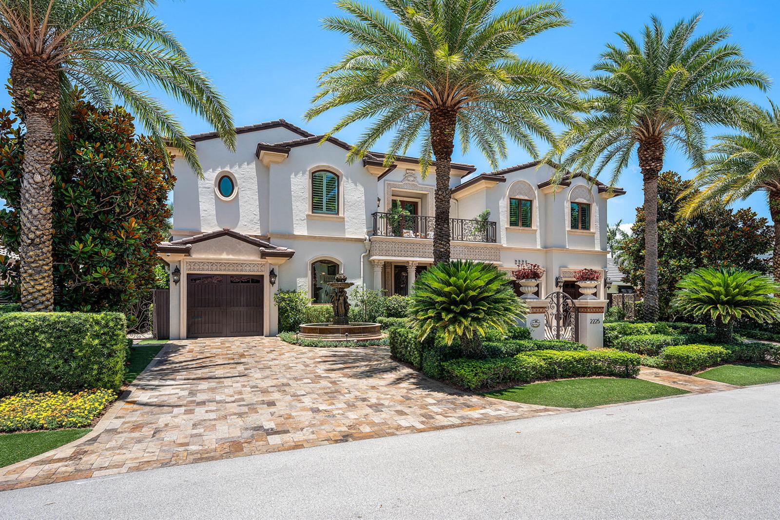 A two-story Mediterranean-style house with a paved driveway, palm trees, and a front fountain — 2225 W Silver Palm Road, Boca Raton FL 33432, BOCA RATON, FL