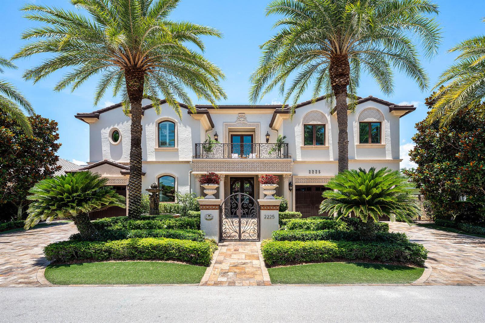 A two-story Mediterranean-style house features a gated entrance, palm trees, and a paved driveway — 2225 W Silver Palm Road, Boca Raton FL 33432, BOCA RATON, FL
