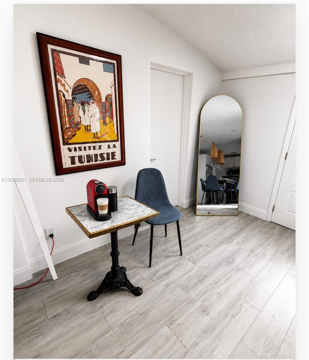 A small corner area features a marble-topped bistro table, a blue chair, and a floor mirror — 5519 NW 4th Ave, Miami FL 33127, MIAMI, FL