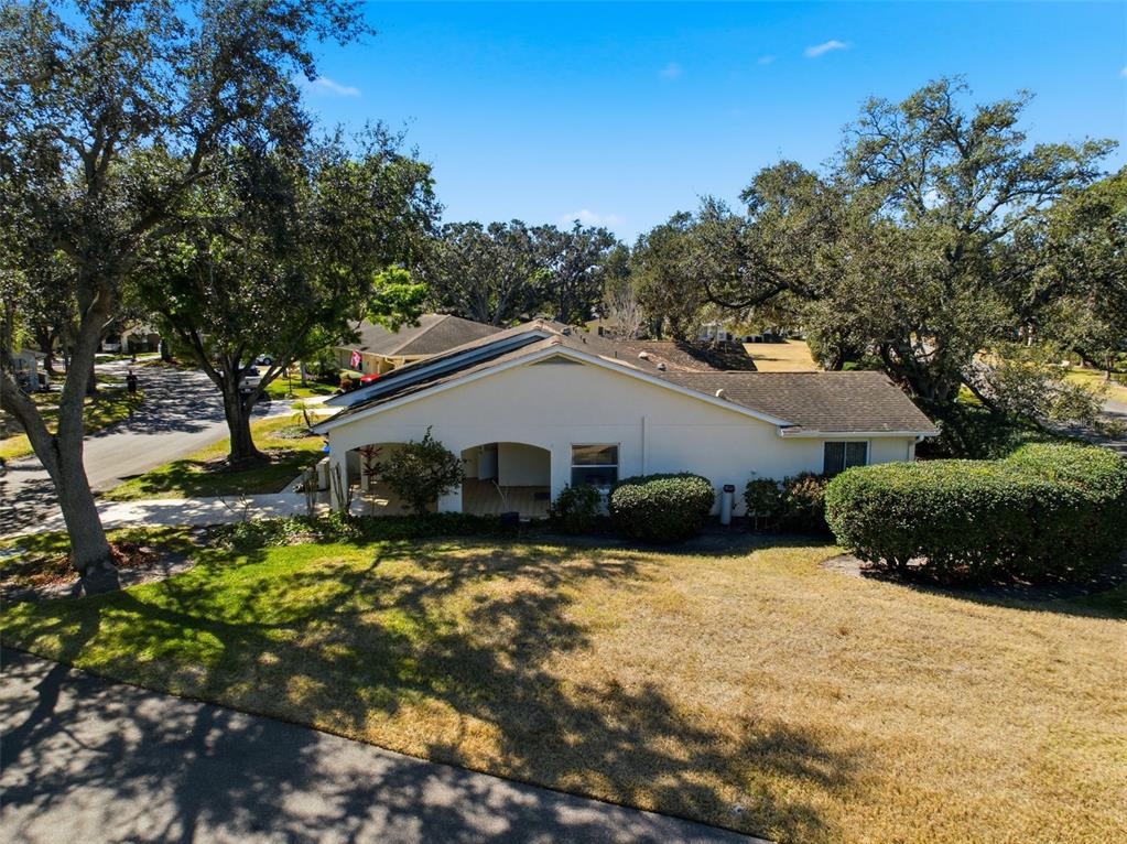An aerial view of a single-story house with a covered patio and surrounding trees — 2101 HAILSTONE CIRCLE UNIT 0, SUN CITY CENTER, FL