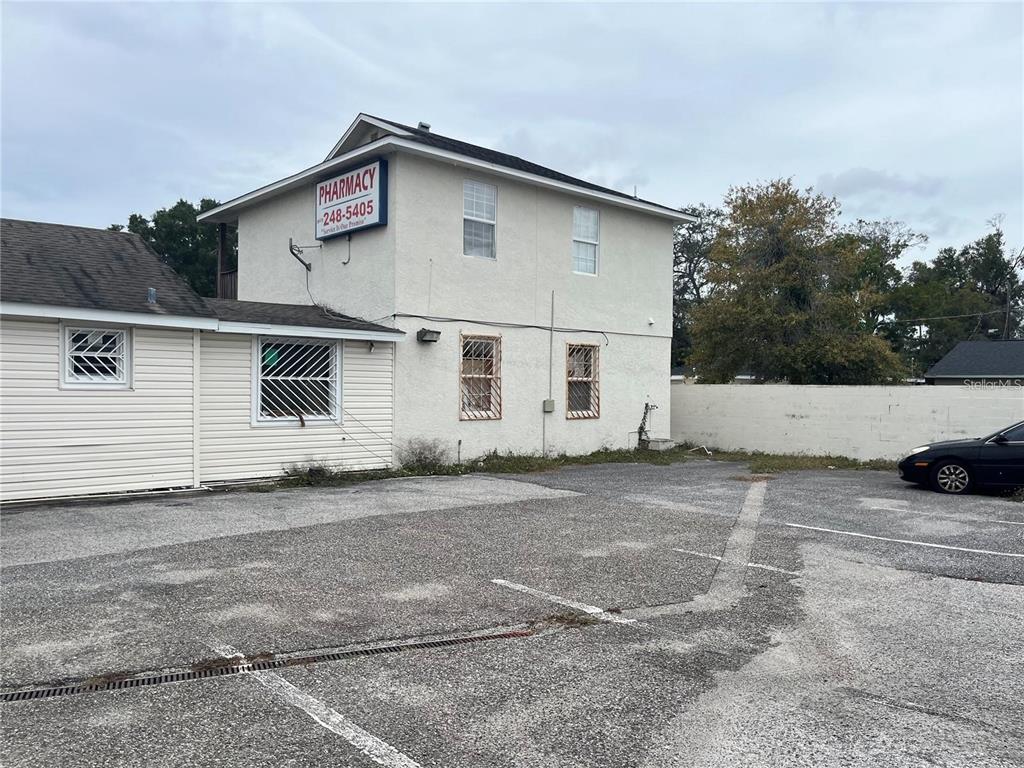 A two-story building with a pharmacy sign stands next to a parking lot — 3302 E DR MARTIN LUTHER KING JR BOULEVARD, TAMPA, FL