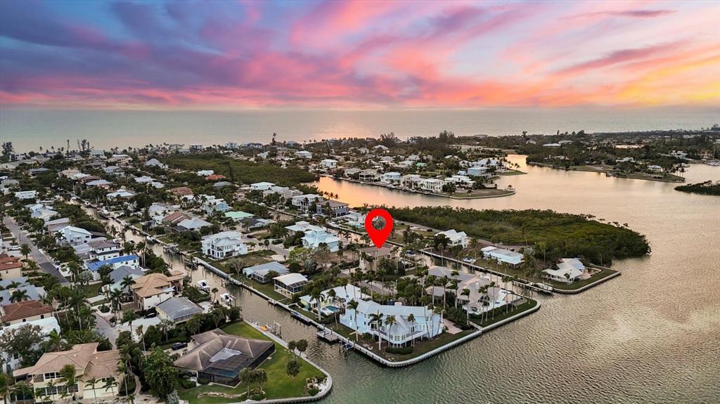 An aerial view shows a waterfront neighborhood with a red location pin over a house — 761 NORTON STREET, LONGBOAT KEY, FL