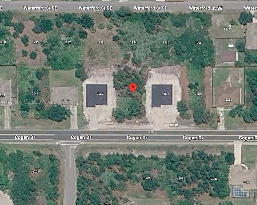 This aerial map shows two houses on Cogan Drive with a vacant lot between them — 2065 SE Cogan Dr, Palm Bay FL 32909, PALM BAY, FL