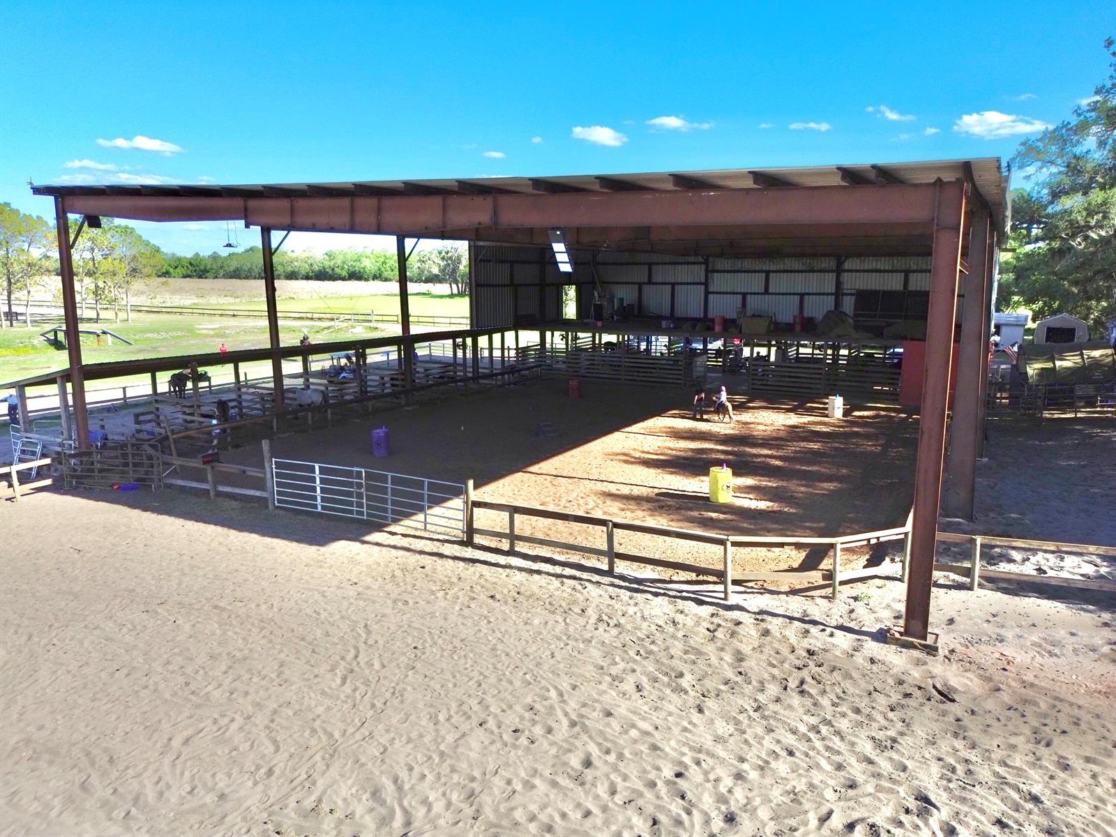 An aerial view of an outdoor covered riding arena with a dirt floor and fencing — 3020 N Bowden Road, FL 33825, FL