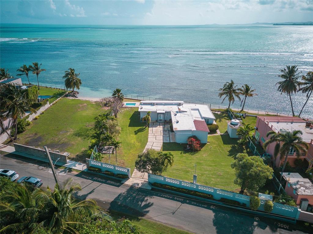 An aerial view of a beachfront house with a large lawn and a swimming pool — 14-2 CAMINO LAS PICUAS, RIO GRANDE, PR