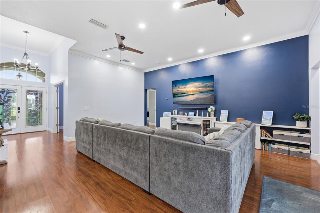 A single-story house with light green siding, stone accents, and a large front lawn — 25672 NW 173RD AVENUE, HIGH SPRINGS, FL