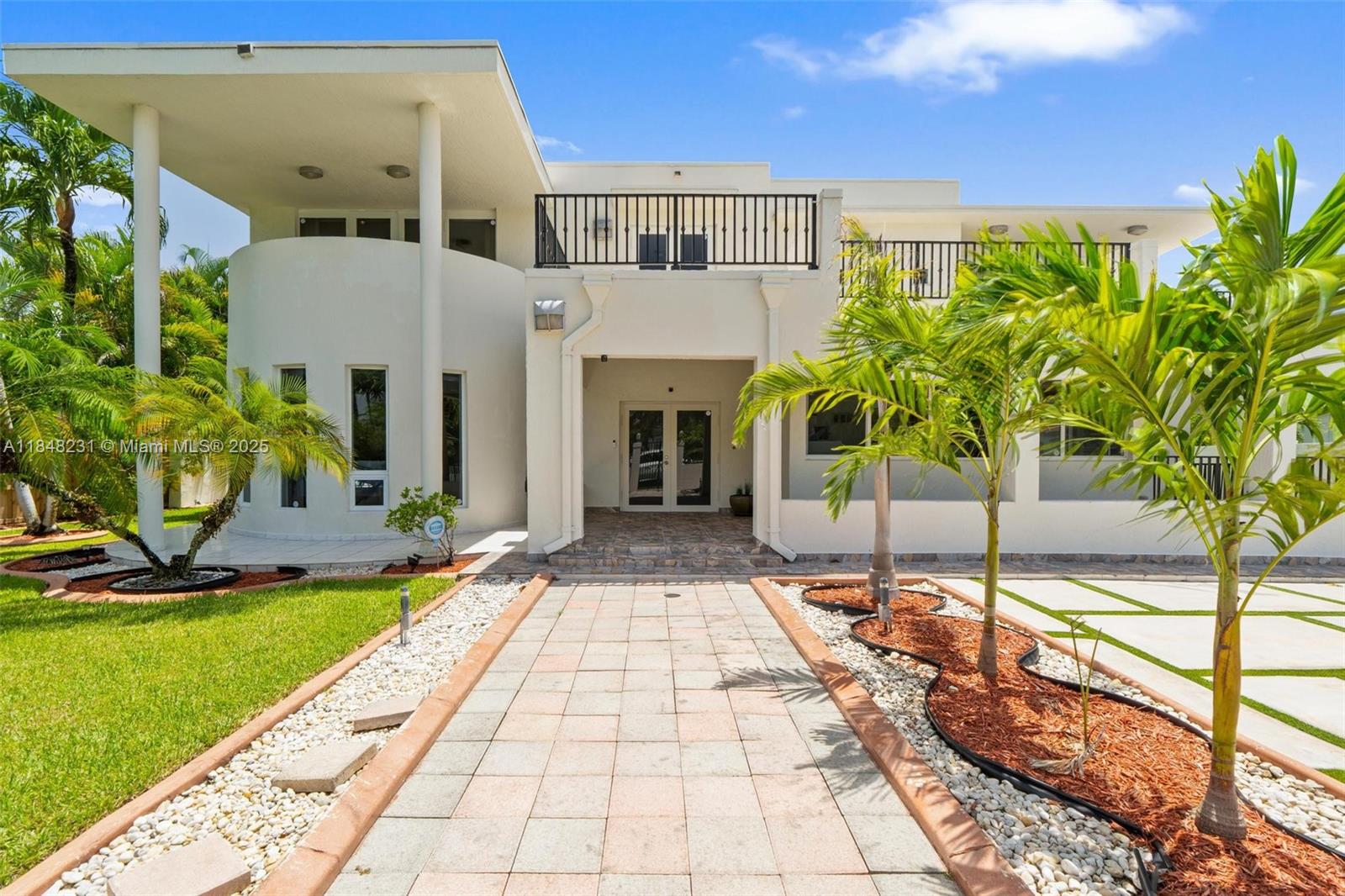 A two-story white modern house features a paved walkway leading to a central front entrance — 5045 SW 67th Ave, South Miami FL 33155, SOUTH MIAMI, FL