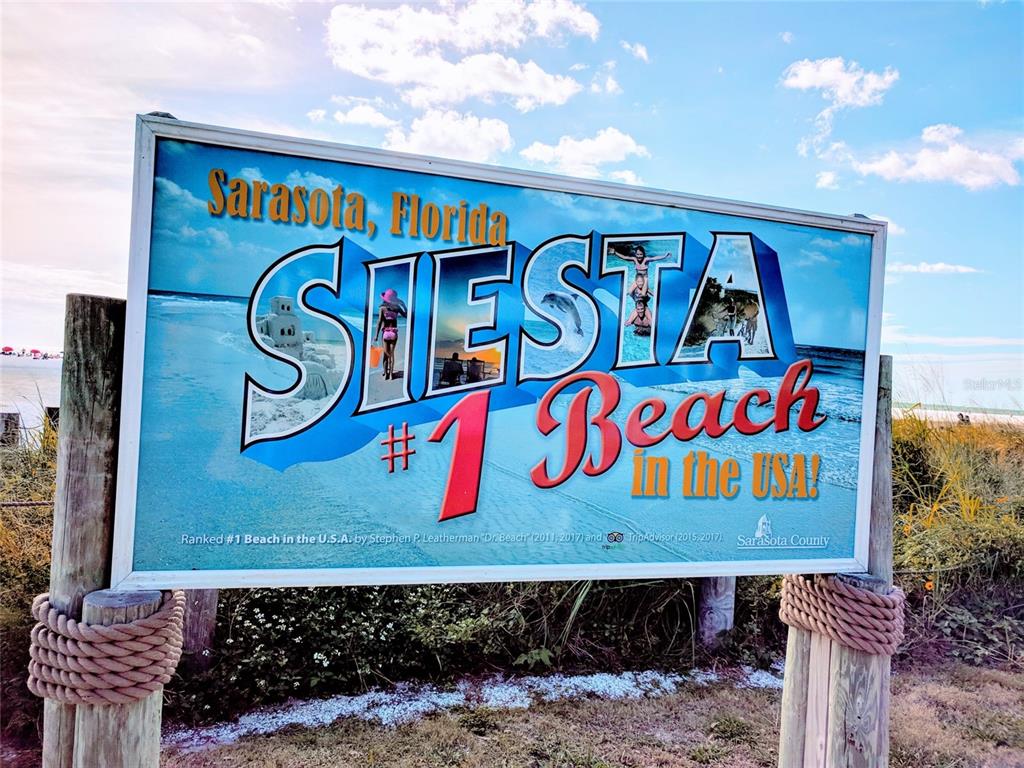 A sign for Siesta Beach in Sarasota, Florida, stands outdoors on wooden posts — ORTIZ BOULEVARD, NORTH PORT, FL