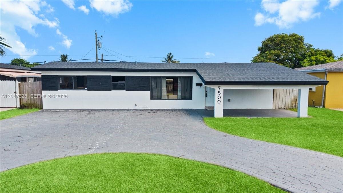 A single-story house with a white facade, black accents, and a covered carport — 7500 Venetian St, Miramar FL 33023, MIRAMAR, FL