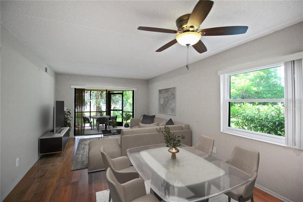 A living and dining room with wood floors, a ceiling fan, and a screened patio — 135 WOODLAKE WYNDE UNIT 135, OLDSMAR, FL