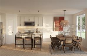 This rendering shows a kitchen with white cabinets and a dining area with a wooden table — 86 SPRINGWOOD DRIVE, PALM COAST, FL