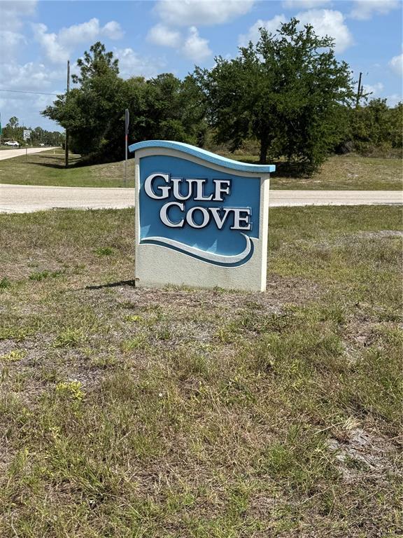 A blue and white Gulf Cove community sign stands in a grassy field — 5101 HOPKINS AVENUE, PORT CHARLOTTE, FL