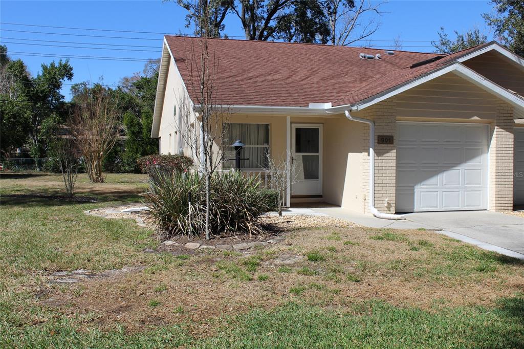 A single-story house with a tan exterior, a brown shingled roof, and a one-car garage — 901 W PENN HILLS COURT UNIT 901, BEVERLY HILLS, FL