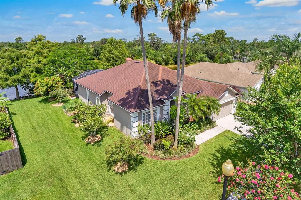 An aerial view of a single-story house with a brown roof and a large lawn — 13903 BLUEWATER CIRCLE, ORLANDO, FL