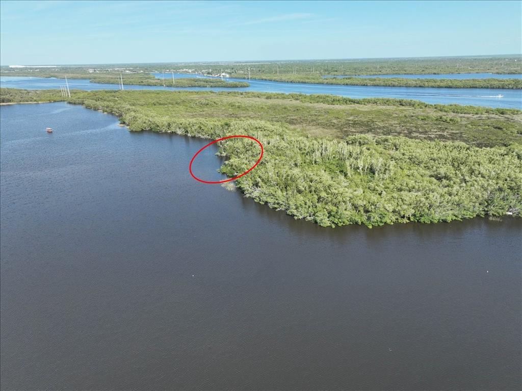 An aerial view shows a red circle highlighting a small inlet along a mangrove shoreline — 2285 DELAN DRIVE, PUNTA GORDA, FL