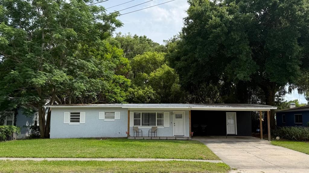 A single-story house with a light blue exterior, a front porch, and a large lawn — 2940 LAKE MARGARET DRIVE, ORLANDO, FL