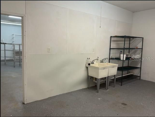 A utility sink stands against a white wall in a room with a concrete floor — 2525 N BETHLEHEM ROAD UNIT A, PLANT CITY, FL