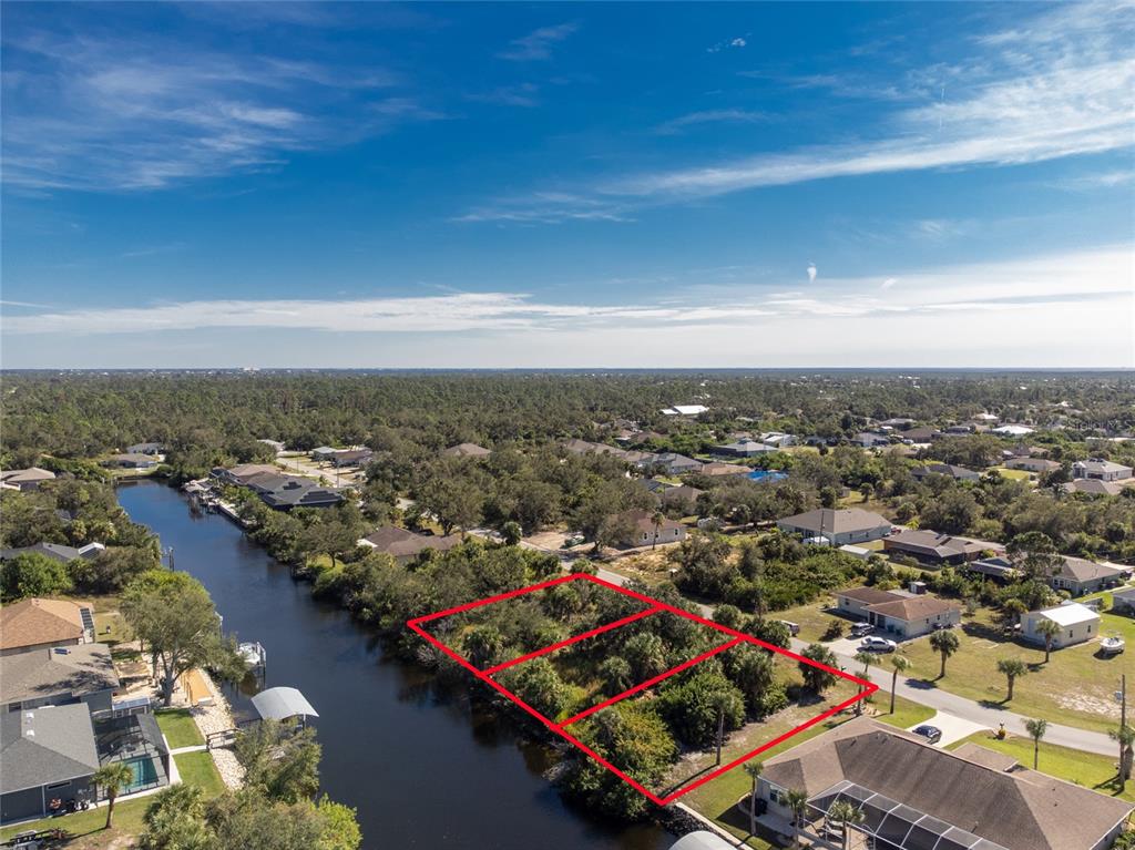 An aerial view shows three adjacent vacant waterfront lots outlined in red along a canal — 17324, 17332, 17340 GULFSPRAY CIRCLE, PORT CHARLOTTE, FL
