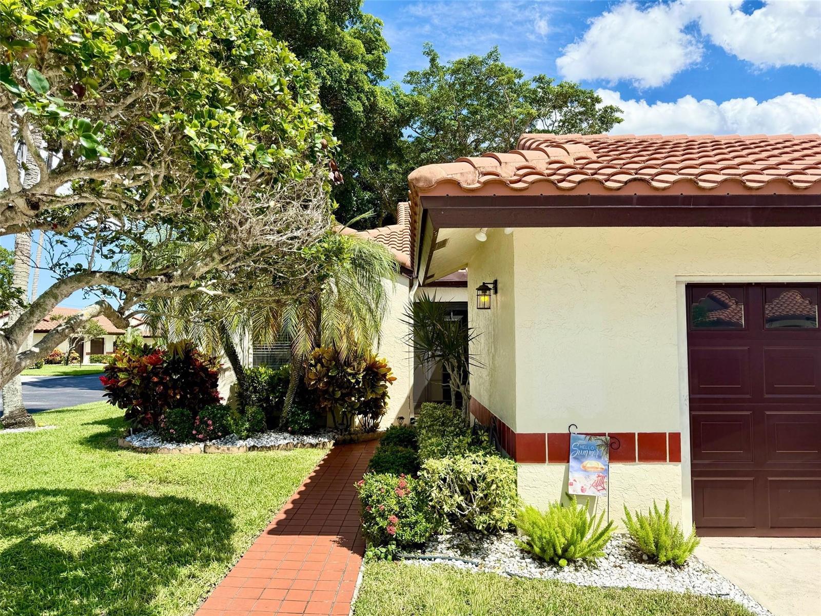 A red brick walkway leads to the entrance of a house with a tile roof — 5462 Palm Springs Lane # A, Boynton Beach FL 33437, BOYNTON BEACH, FL