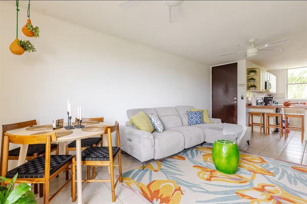 A living room and dining area with a light gray sectional sofa and wooden chairs — COLONIA SANTA MARIA COSTA BRAVA CONDOMINIUM UNIT 8-401, CEIBA, PR
