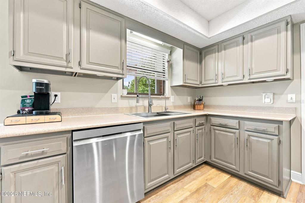 A kitchen features gray cabinets, stainless steel appliances, and light-colored countertops — 12432 MUSCOVY DRIVE, JACKSONVILLE, FL