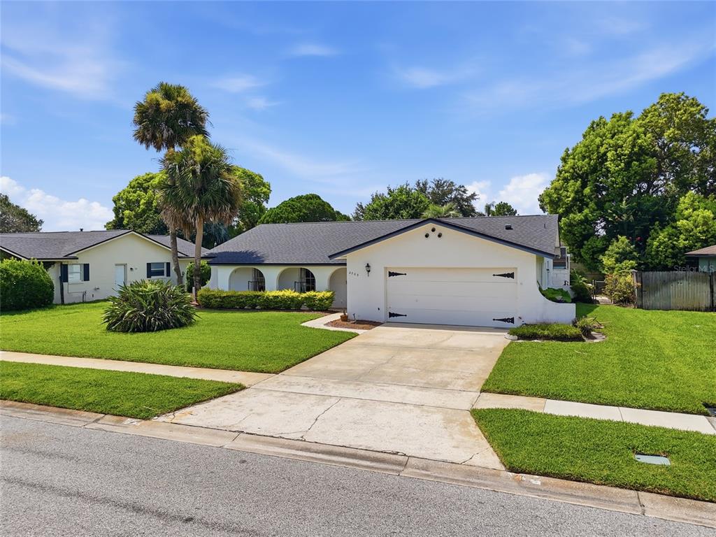 An entryway features white tile floors, a wooden front door, and swinging louvered doors — 2703 TIERRA CIRCLE, WINTER PARK, FL