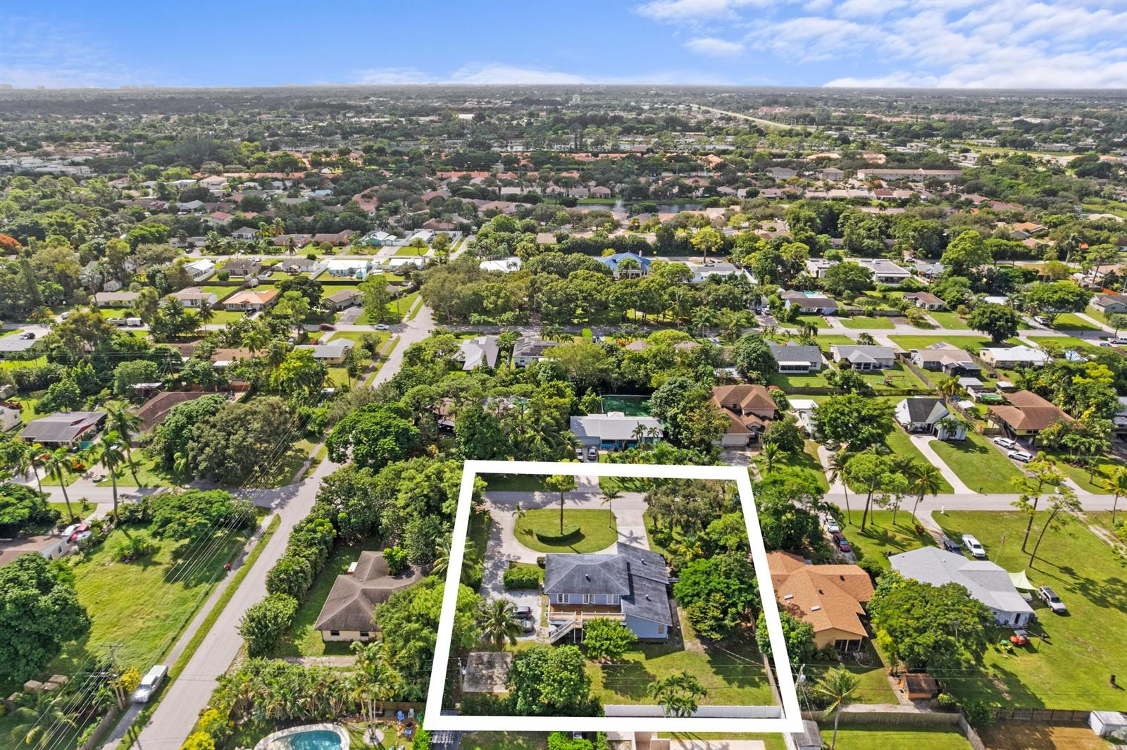 An aerial view shows a residential house with a large yard inside a white border — 5285 Sunrise Boulevard, Delray Beach FL 33484, DELRAY BEACH, FL