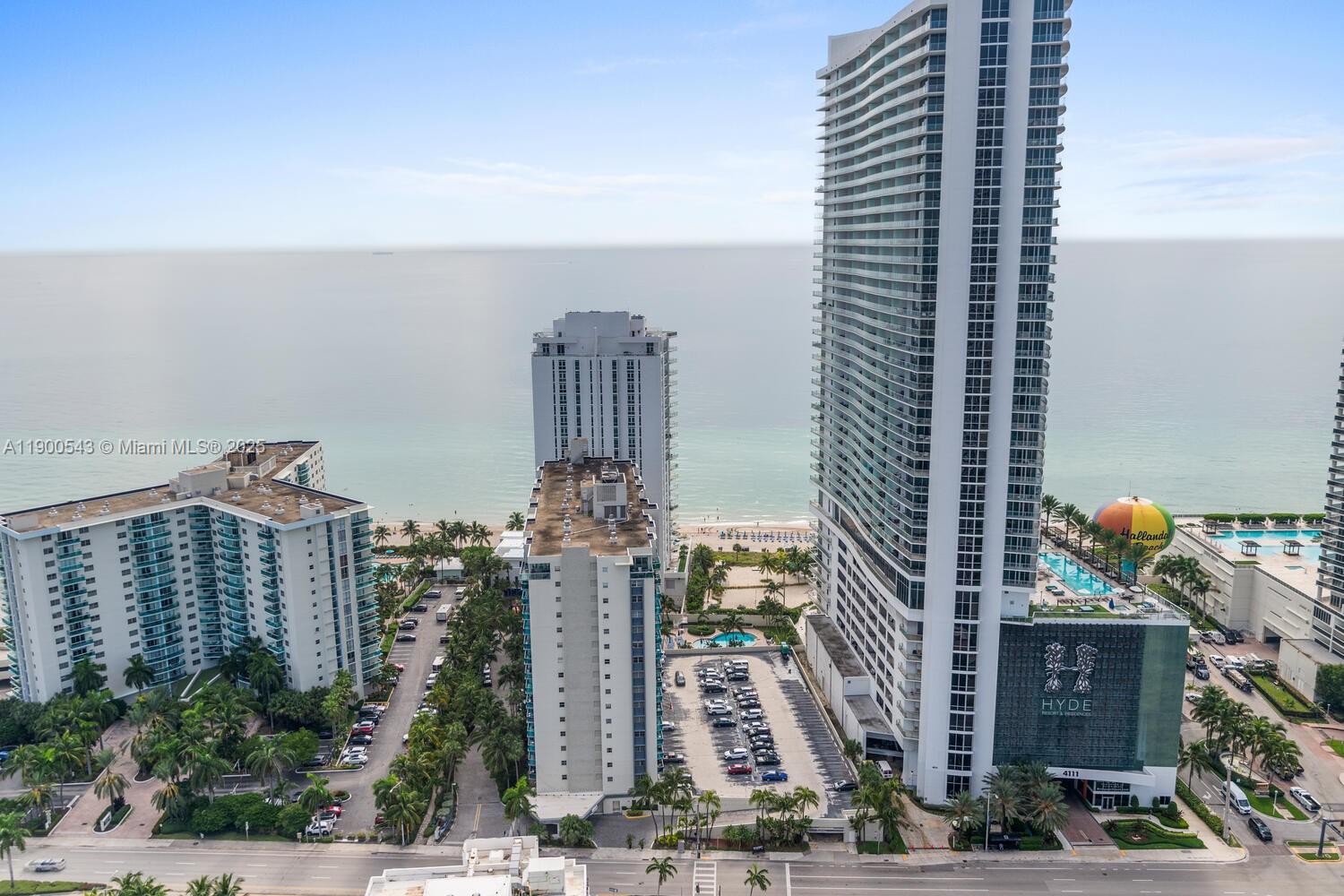 An aerial view shows several high-rise residential buildings situated along a sandy beach — 4010 S Ocean Dr # R2501, Hollywood FL 33019, HOLLYWOOD, FL