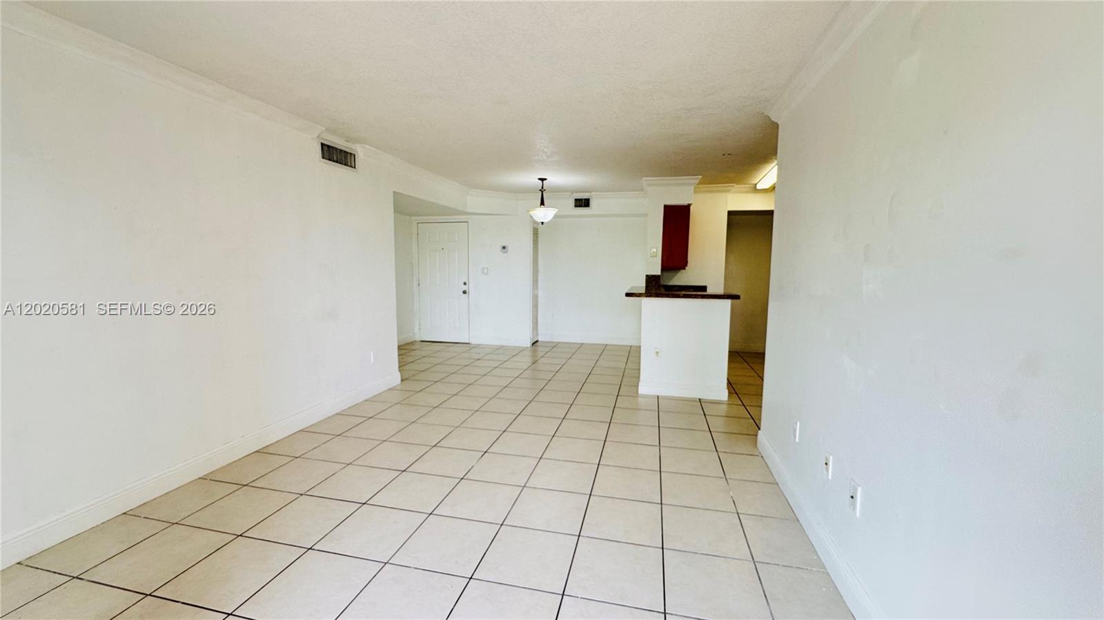 A living room with light gray walls, tile flooring, and a sliding glass door to a balcony — 15221 SW 80th St # 406, Miami FL 33193, MIAMI, FL