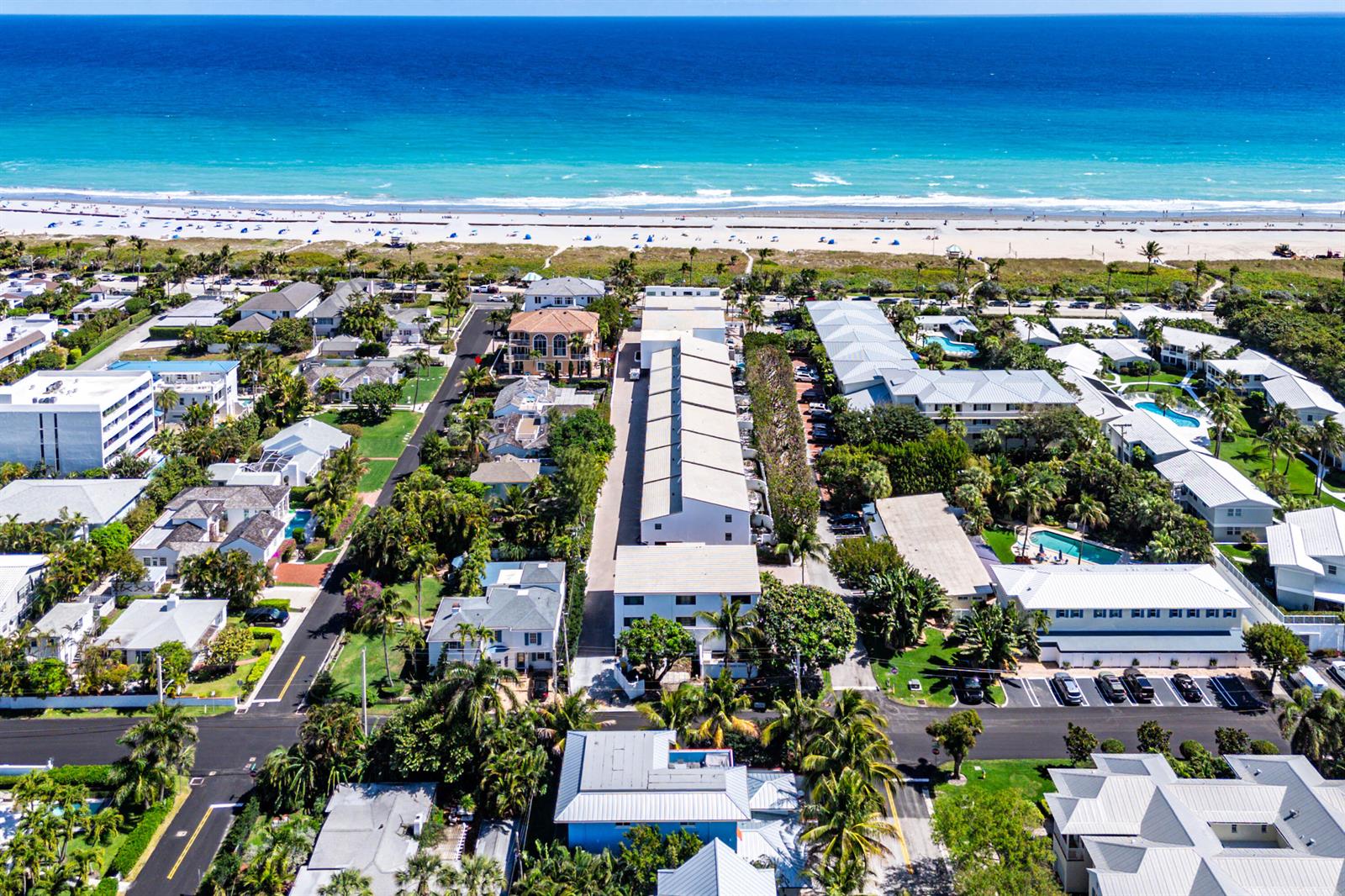 An aerial view shows a coastal neighborhood with houses, apartment buildings, and a sandy beach — 250 S Ocean Boulevard # 269, Delray Beach FL 33483, DELRAY BEACH, FL