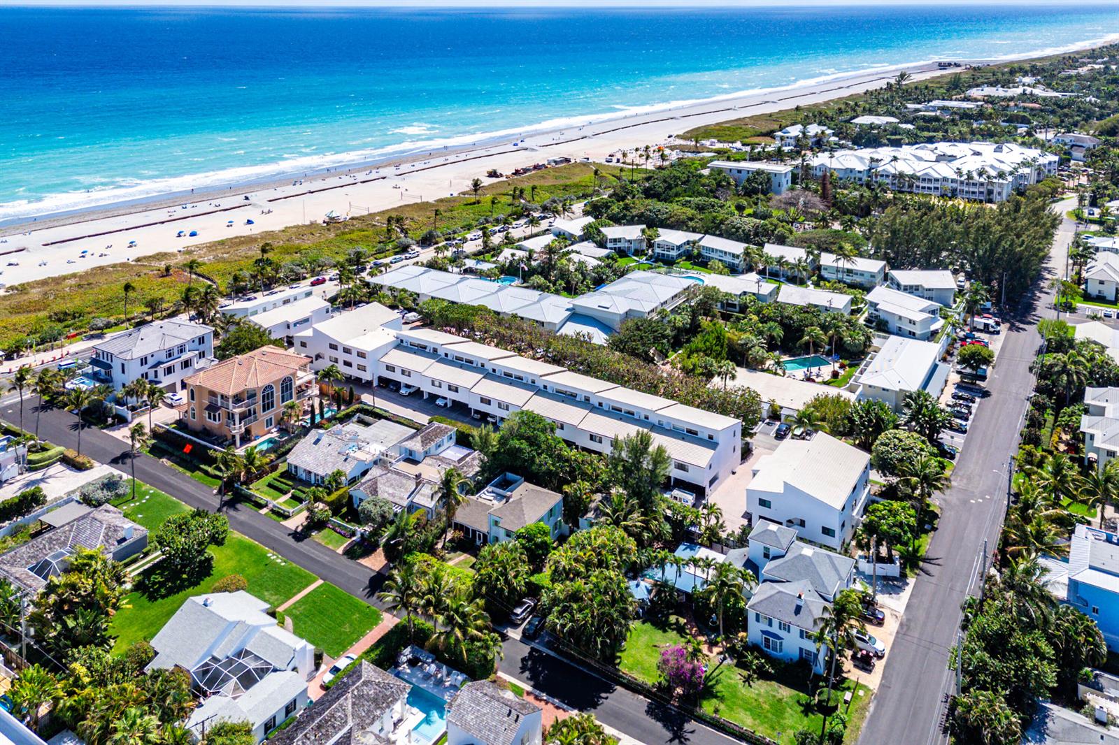An aerial view shows a coastal neighborhood with multi-story residential buildings near a sandy beach — 250 S Ocean Boulevard # 269, Delray Beach FL 33483, DELRAY BEACH, FL