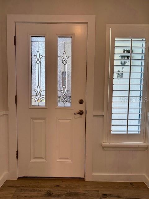 A white front door with two glass panels sits next to a window with shutters — 1637 SE PARADISE CIRCLE UNIT 205, CRYSTAL RIVER, FL