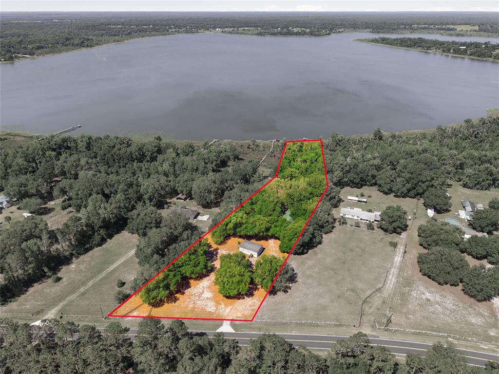 An aerial view shows a rectangular property with a house, trees, and lakefront access — 3980 SE 183RD AVENUE ROAD, OCKLAWAHA, FL