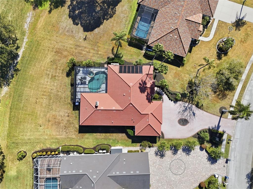 A screened-in pool and spa area with a paved patio overlooking a grassy golf course — 7321 LINKS COURT, SARASOTA, FL
