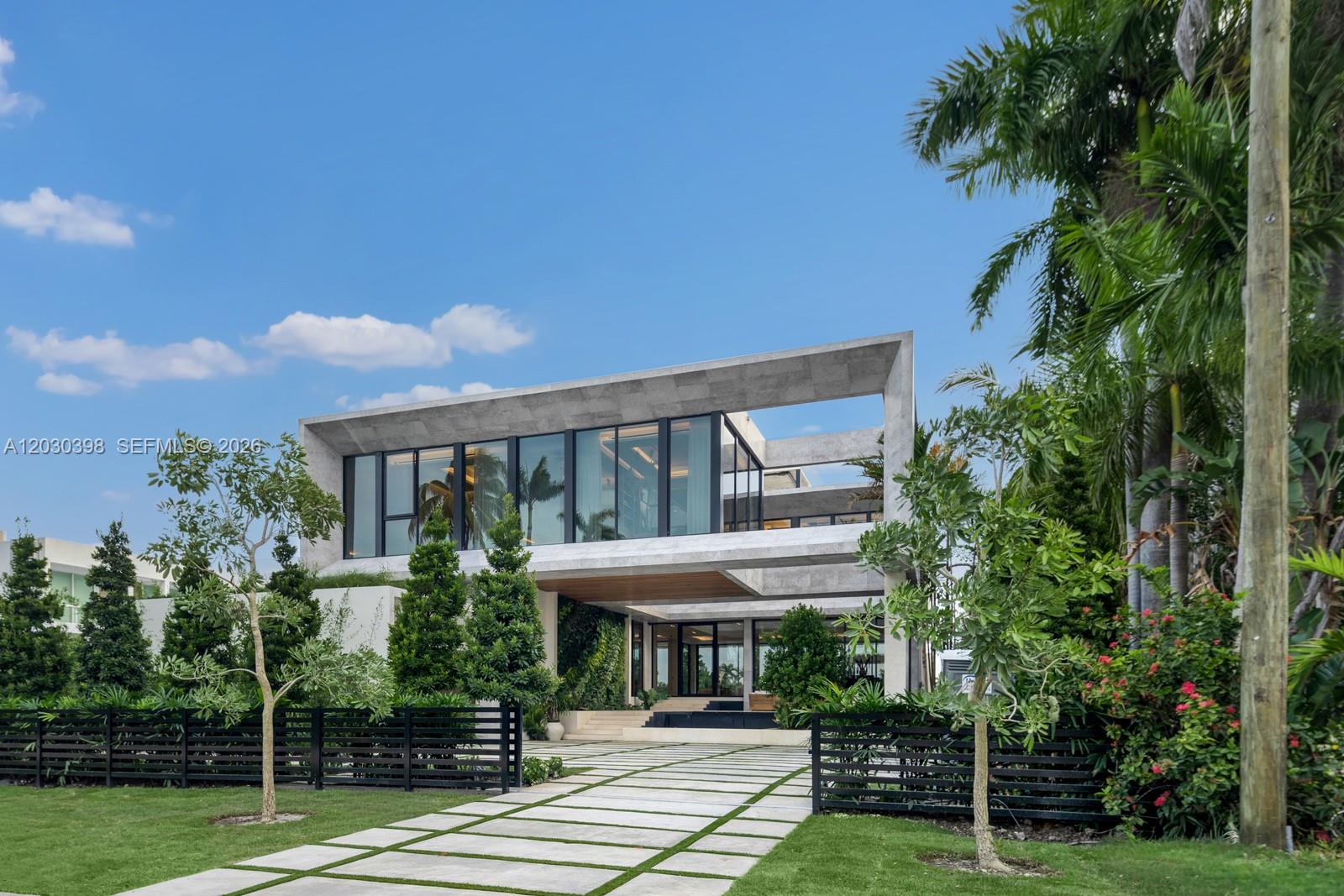 A modern two-story concrete house features large glass windows and a paved driveway — 360 S Hibiscus Drive, Miami Beach FL 33139, MIAMI BEACH, FL