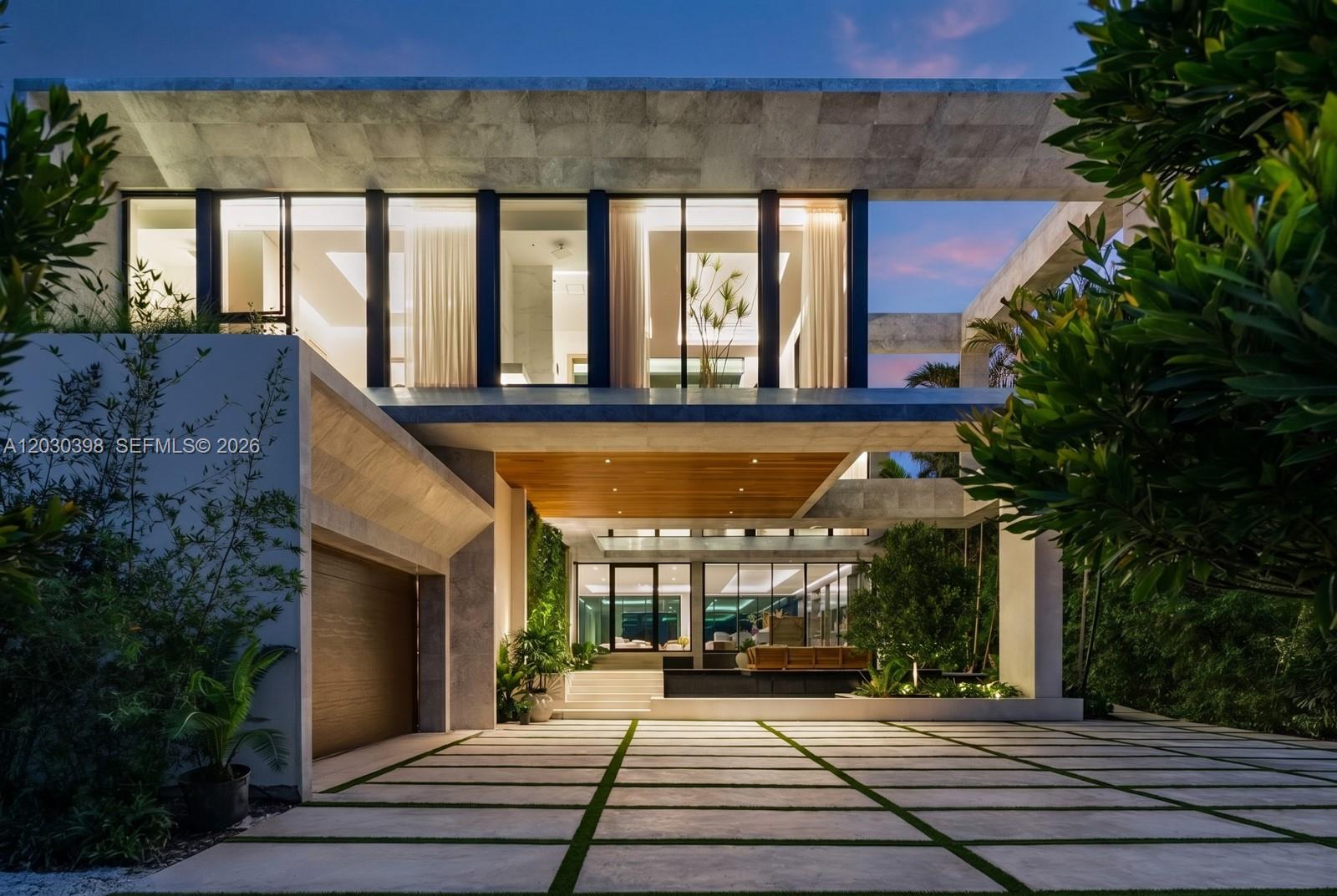 A modern two-story house with a stone facade, wood-paneled ceiling, and a paved driveway — 360 S Hibiscus Drive, Miami Beach FL 33139, MIAMI BEACH, FL