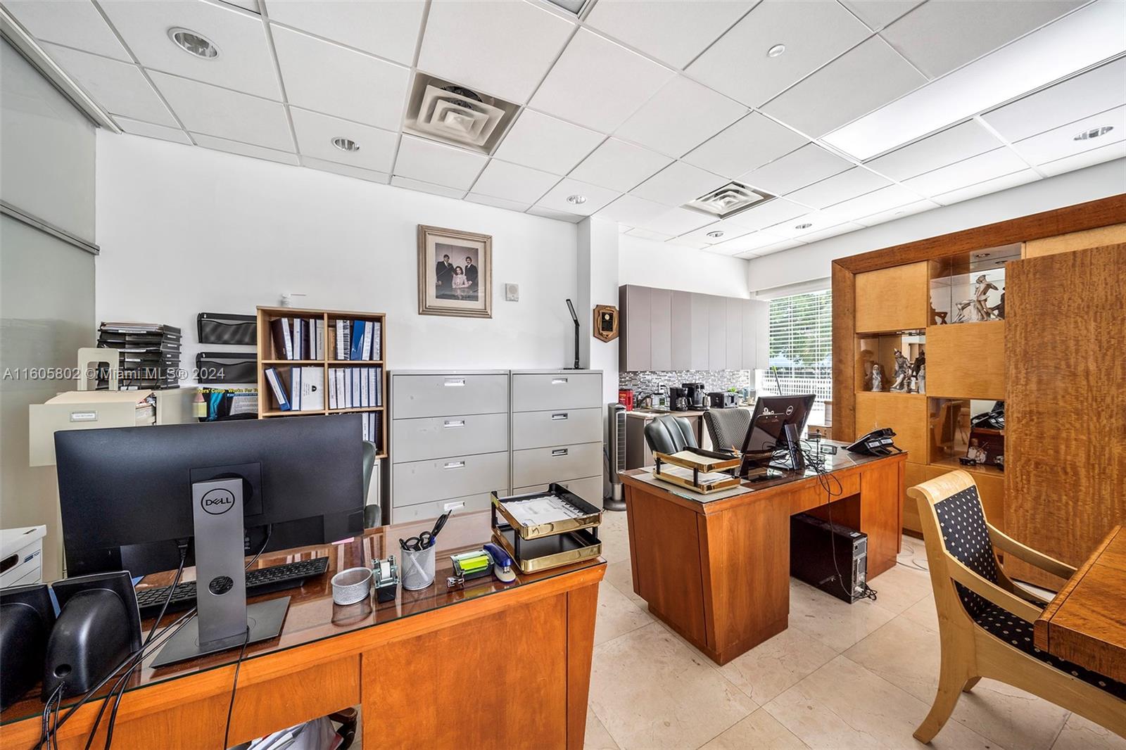 An office space features two wooden desks, filing cabinets, and a drop ceiling — 2101 Brickell Ave, Miami FL 33129, MIAMI, FL